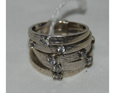5 Sectioned white metal ring set with 9 diamonds.