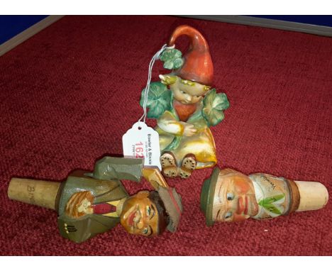 Early 1920's Goebel girl sitting with 4 leaf clovers figurine, together with 2 carved brandy stoppers with moving actions 