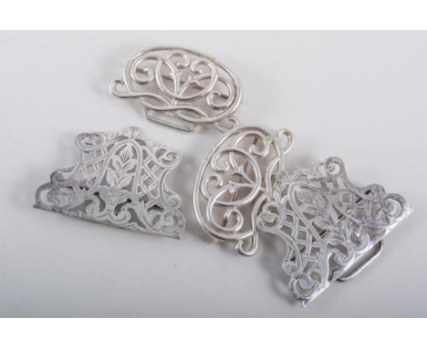 A silver nurses belt buckle, hallmarked Birmingham 1900, another pierced and engraved silver-plated buckle, plus a Victorian 
