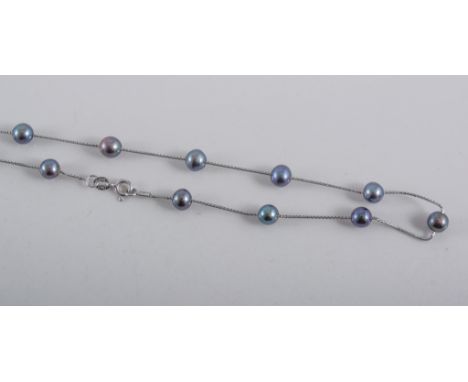 A black pearl necklace, fifteen 6mm pearls spaced along a fine silver coloured box link chain stamped 925, 38cm long.