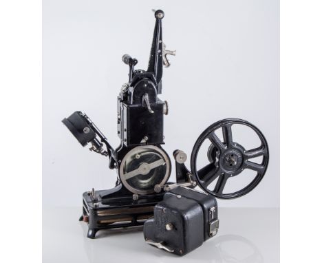 Early cine-film projector, with large number of reels, with booklets and cases. 