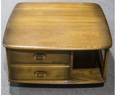 An Ercol "Pandora's Box" coffee table, with two drawers and open recesses below the rounded square top, raised on castors, wi