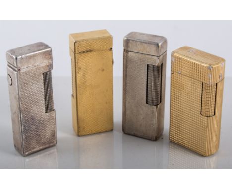 Four Dunhill cigarette lighters, a gold-plated hobnail design lighter 6cm x 3cm, another slim gold-plated lighter with a fine