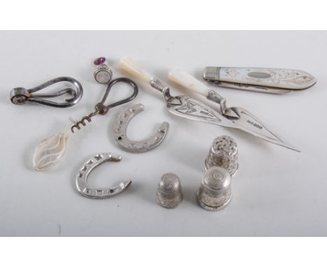 Two silver and mother of pearl 'trowel' page clips, three silver thimbles, three horseshoe tokens, silver and mother of pearl