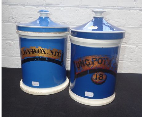 PAIR OF BLUE CERAMIC APOTHECARY JARS with gilded lettering 26cm high approx (chips)