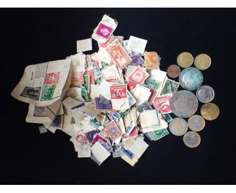 A BAG OF MIXED LOOSE VINTAGE INTERNATIONAL STAMPS together with some coins