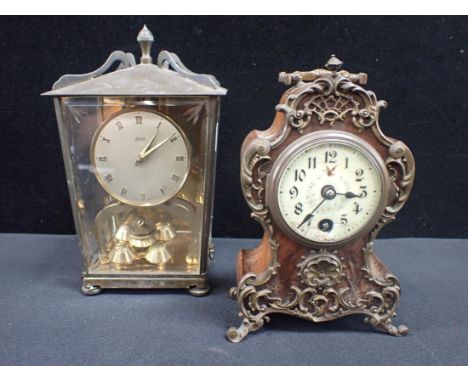 A ROCOCO STYLE MANTEL OR BEDROOM CLOCK with gilded mounts, late Victorian, 18cm high, with a modern German clock in a glazed 