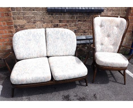 ERCOL: A DARK FINISH WINDSOR 203 TWO-SEATER SOFA 135cm wide, and high-backed 478 armchair 76cm wide (chair retains label, som
