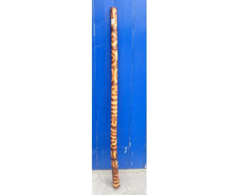 A BAMBOO PIPE OR DIGERIDOO with 'tortoiseshell' markings 158cm long