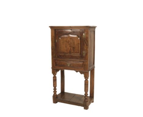 GEORGE III STYLE OAK CABINET ON STAND, the rectangular door with an ogee arched panel over a drawer, on a stand with turned f