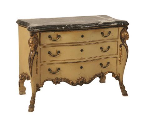 BAROQUE STYLE CREAM AND PARCEL-GILT COMMODE of serpentine form, with a black and white marble top over three graduated drawer