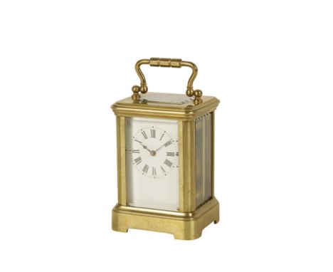 FRENCH MINIATURE BRASS CASED CARRIAGE CLOCK the white enamel dial with Roman numerals, in a plain brass case with swing handl