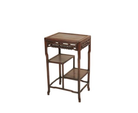 CHINESE ROSEWOOD STAND with a rectangular floating-panel top over the carved and pierced frieze and two staggered shelves, 45