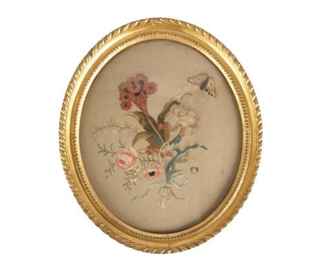 GEORGE III OVAL SILKWORK PANEL of a butterfly and flowers tied with ribbon, in a beaded and gadrooned giltwood frame, 45cm x 
