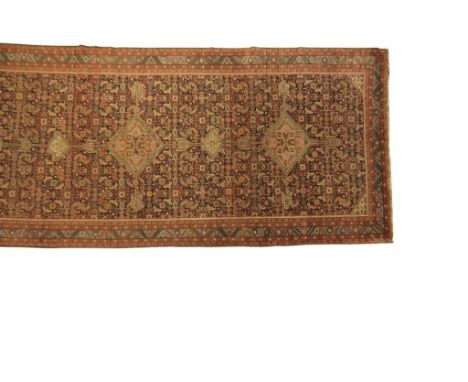 FINE BAKSHAISH LONG CARPET, North West Persia, 19th century, the rectangular indigo field with three principal geometric meda