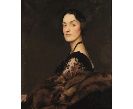 GEORGE SPENCER WATSON (1869-1934) A half length portrait of an elegant lady, seated wearing a black dress with lace arms and 