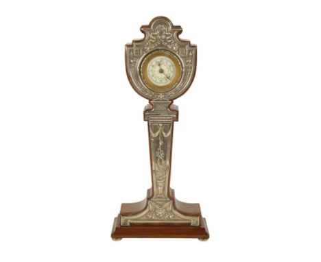 EDWARDIAN SILVER AND MAHOGANY TABLE CLOCK, the round dial with Arabic numerals, in a fitted mahogany case, the silver front p