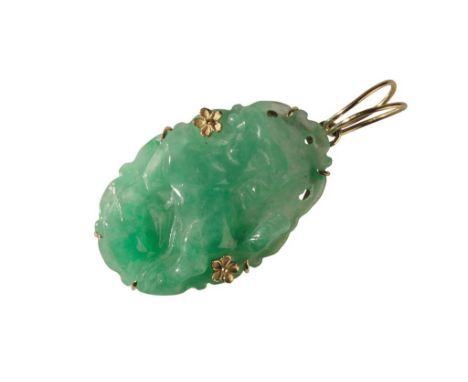 JADE PENDANT the oval pendant decorated with a mythical dog, and two unmarked yellow metal flowers, the pierced top edge atta