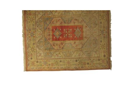 SOUTH WEST TURKISH MILAS TYPE SMALL CARPET, the pale yellow and blue ground worked with flowers and leaf motifs with a centra