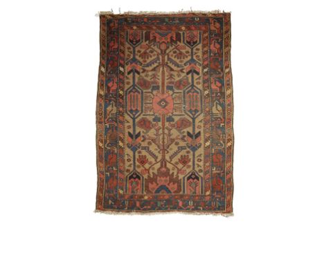 CAUCASIAN TRIBAL RUG of Heriz type, the ivory ground central rectangular panel worked with salmon pink and blue stylised flor