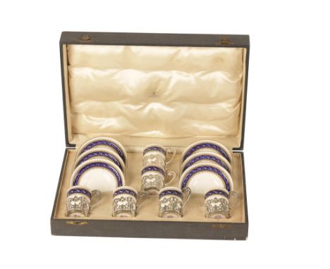 SET OF SIX ROYAL WORCESTER COFFEE CANS AND SAUCERS the cream ground with royal blue and gilt banding, printed mark, in pierce