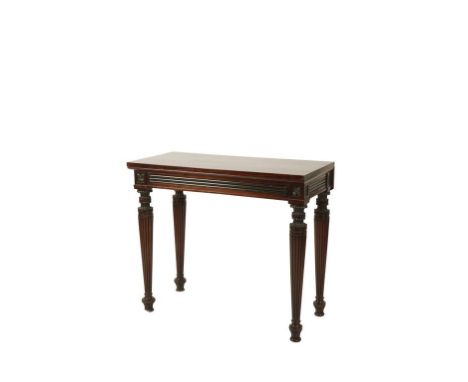 GEORGE IV MAHOGANY CONSOLE TABLE, circa 1825, the rectangular top above an ebonised reeded frieze, raised on turned a reeded 