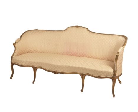 GEORGE III STYLE GILTWOOD SOFA of Hepplewhite design with a serpentine seat and a shaped frame carved with foliage and acanth