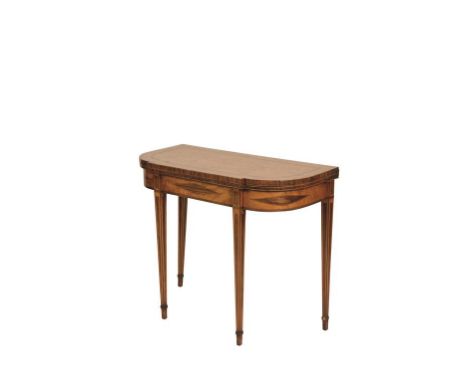 A GEORGE III SATINWOOD CARD TABLE of Sheraton design, inlaid with banding throughout, the folding "D"-shaped top with a strai