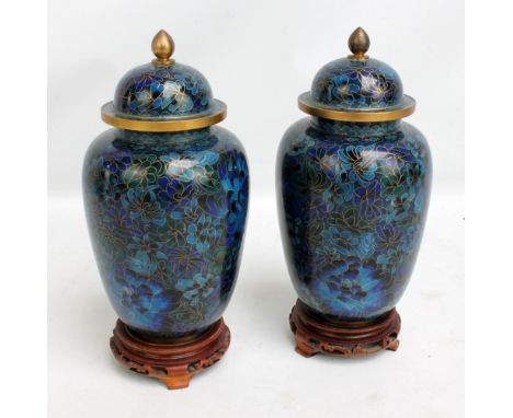 A pair of Chinese cloisonné enamel on blue ground lidded vases, both with wooden stands, height including lid (excluding stan