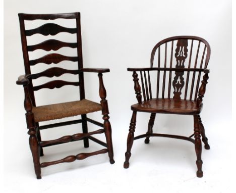 A mid-19th century ash and elm low hoop back Windsor elbow chair with crinoline stretcher and an oversized ladder back elbow 