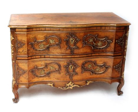 A large 18th century German walnut serpentine front commode, the inlaid and crossbanded top above two long drawers, each set 