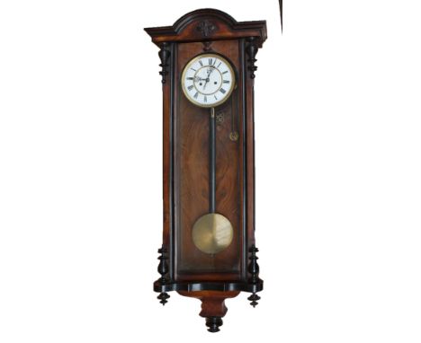 A Vienna walnut and stained beech eight day striking weight driven wall clock, the circular two sectioned dial set with Roman