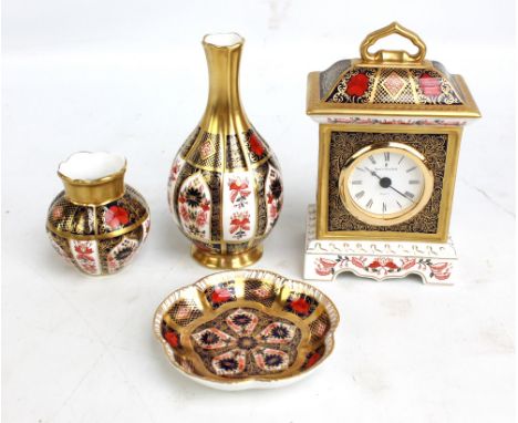 A Royal Crown Derby 'Old Imari' pattern mantel clock, height 17cm, a bottle vase, a smaller vase and a dish (4). CONDITION RE