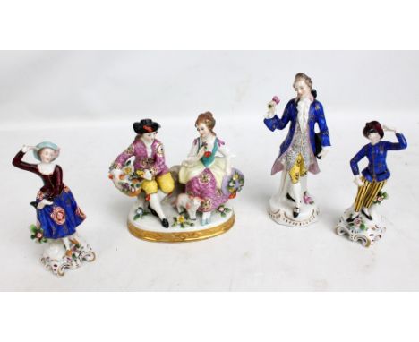 A ceramic figure group and three single figures of ladies and gentlemen in elaborate dress with painted and gilt decoration, 