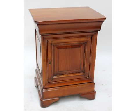 A reproduction pot cupboard with panelled cupboard door and raised on bracket feet.