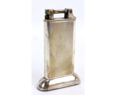 DUNHILL; an electroplated table lighter with engine turned decoration, height 10cm.