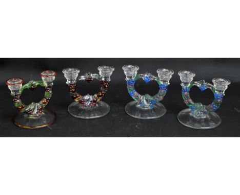 A pair of 1940s Art Deco style clear and variously tinted glass candlesticks with fruit wreath shaped stems, height 14cm, and