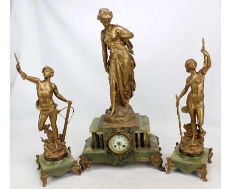 A circa 1900 French onyx and gilt metal mounted three piece clock garniture with figural mount, brass columns and circular di