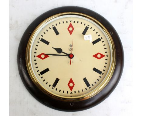 A George VI GPO mahogany framed circular slave wall clock, the dial set with baton and lozenge numerals, with later battery m