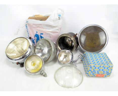 A quantity of vintage car lamps including examples by Miller and Bosch.