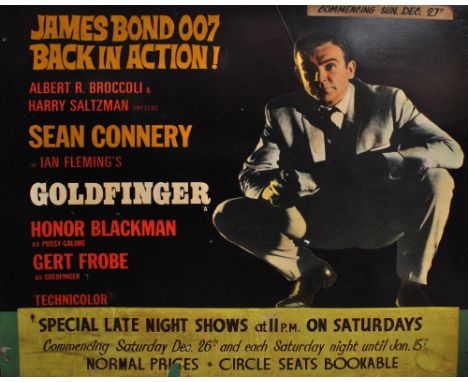A wooden cinema advertising board for Goldfinger with cutout of Sean Connery as James Bond 007 listing showings as commencing