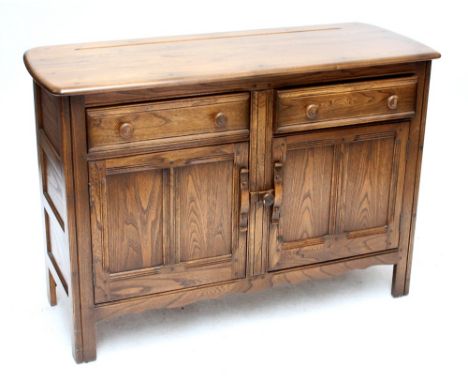 ERCOL; an elm sideboard with two drawers above cupboard doors, width 119cm.