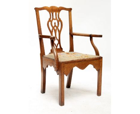A Georgian oak country Chippendale style elbow chair. 