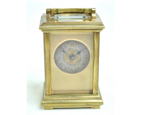 A 19th century French brass carriage clock, the circular silvered dial set with Arabic numerals and with applied bead decorat
