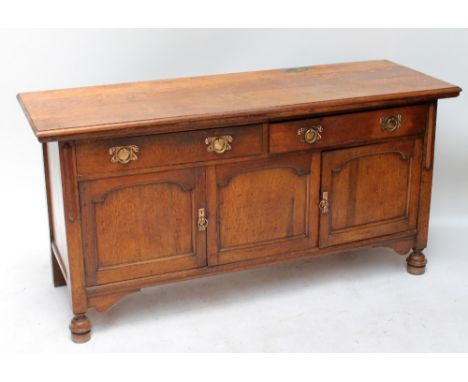 An Arts and Crafts oak sideboard, width 167cm. CONDITION REPORT: We are not able to transport this item to the USA, we would 