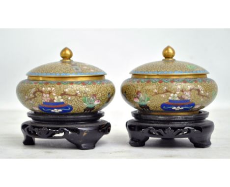 A pair of cloisonné enamel bowls and covers on stands, internal diameter 7.9cm (2). CONDITION REPORT: Surface wear, manufactu