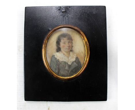 A late 18th century ivory half length portrait miniature depicting a boy with dark hair, with inscription verso, 7 x 5.5cm, f