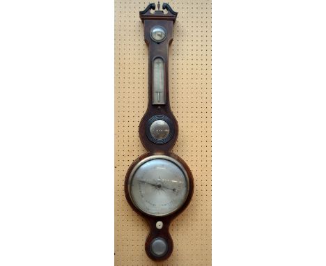 An early 19th century mahogany and boxwood strung five dial wheel barometer with broken swan neck pediment, length 97cm.
