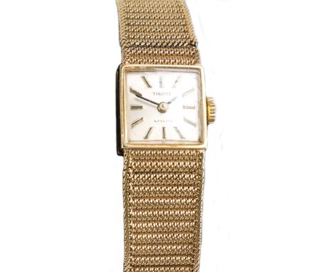 TISSOT; a 9ct gold lady's manual wind wristwatch, the square dial set with baton numerals, with integral textured bracelet (a
