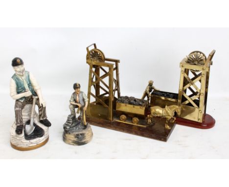 Two brass of models of pit headgears, on wooden plinths, a ceramic figure of a miner and a smaller musical example (4).